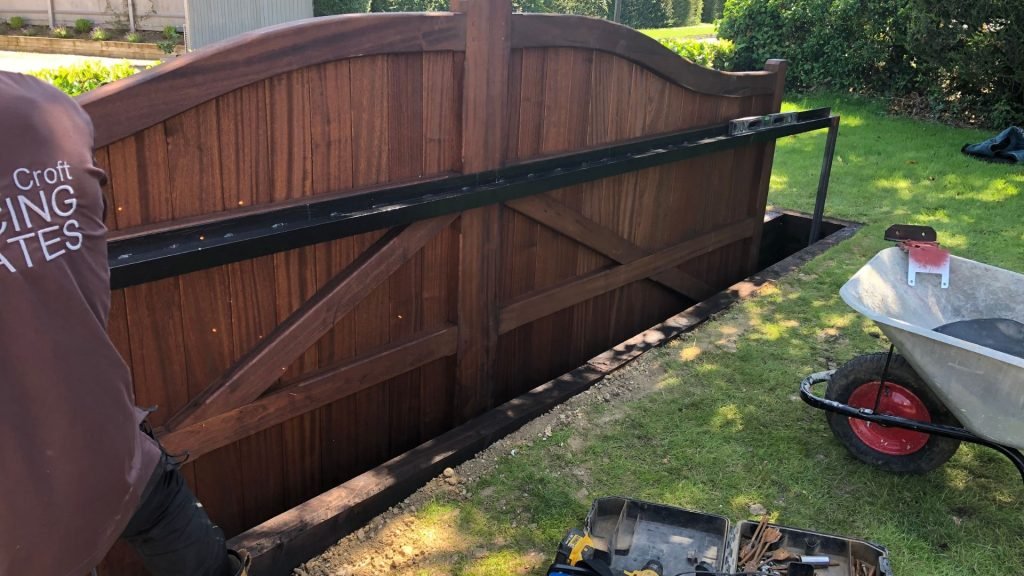 Bow top Essex gates on sliding gate automation with retaining wall