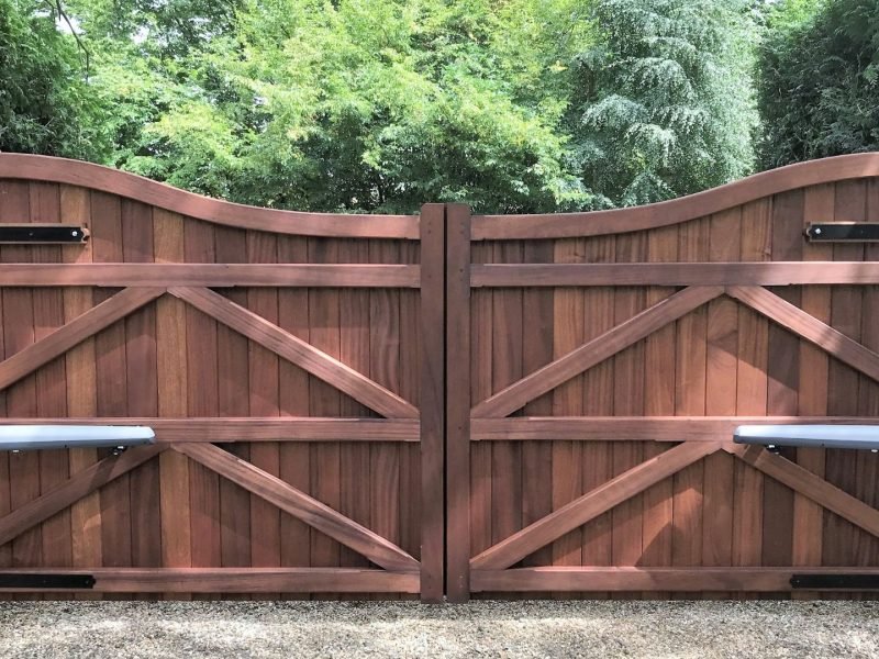 Inverted bow topped hardwood entrance gates with gate automation in essex