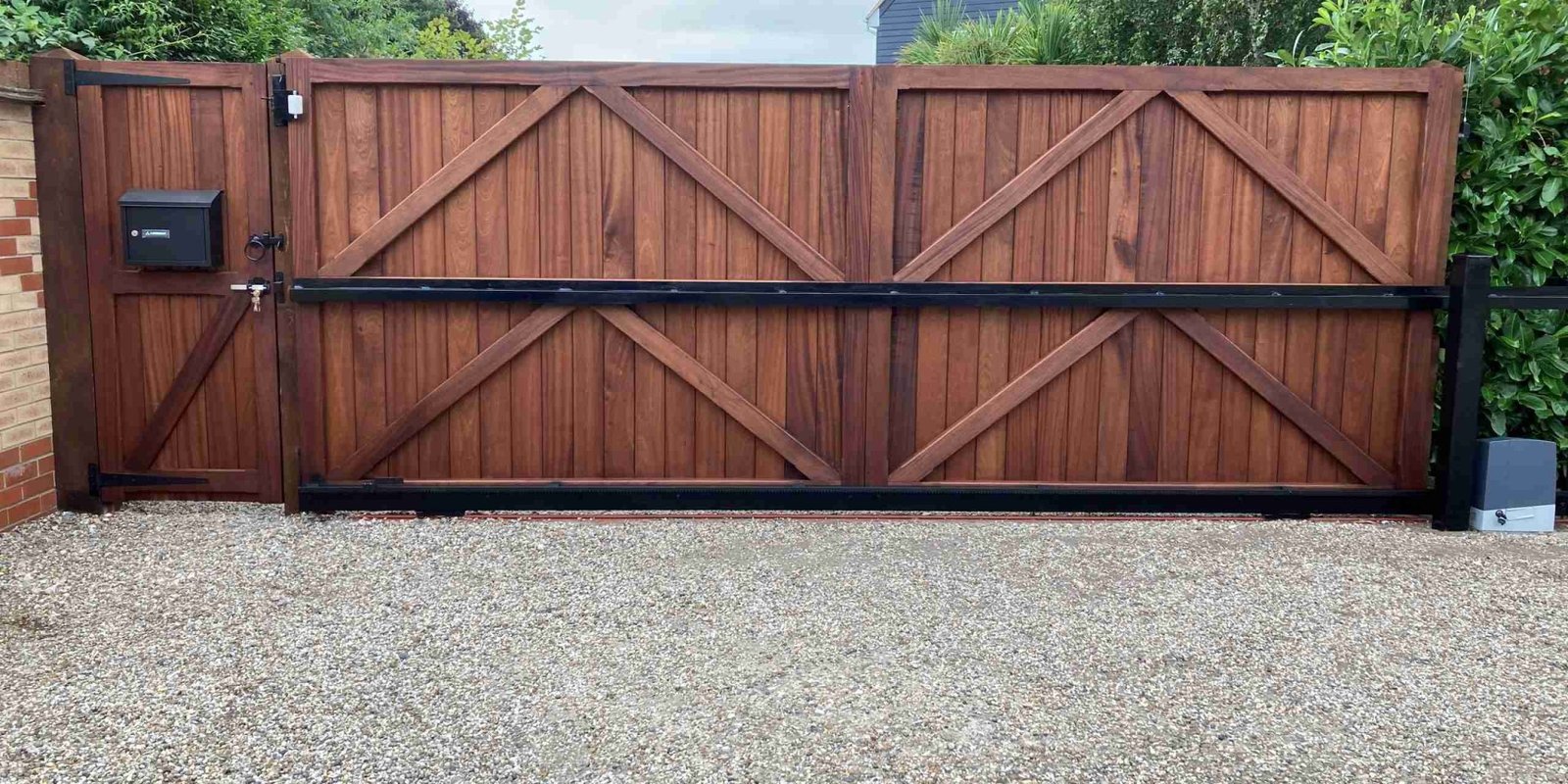 Hardwood Straight Top Driveway gates with sliding automation and matching side gate Tarmec and Croft